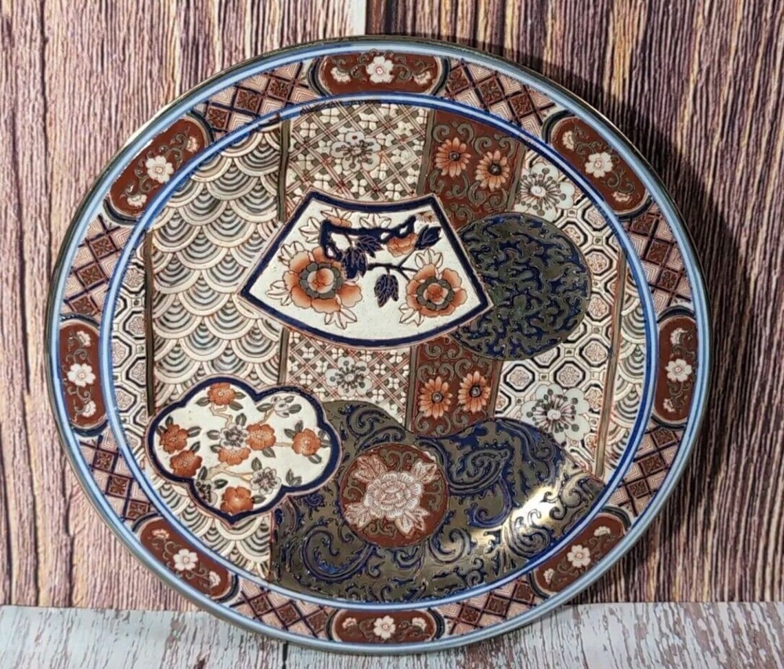 Close view of the decorated porcelain surface and traditional Imari style motifs